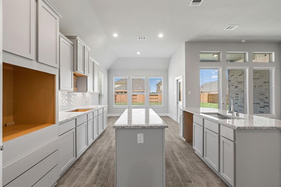 This generously spacious kitchen is a dream realized! Sample photo of completed home with similar floor plan. As-built interior colors and selections may vary.