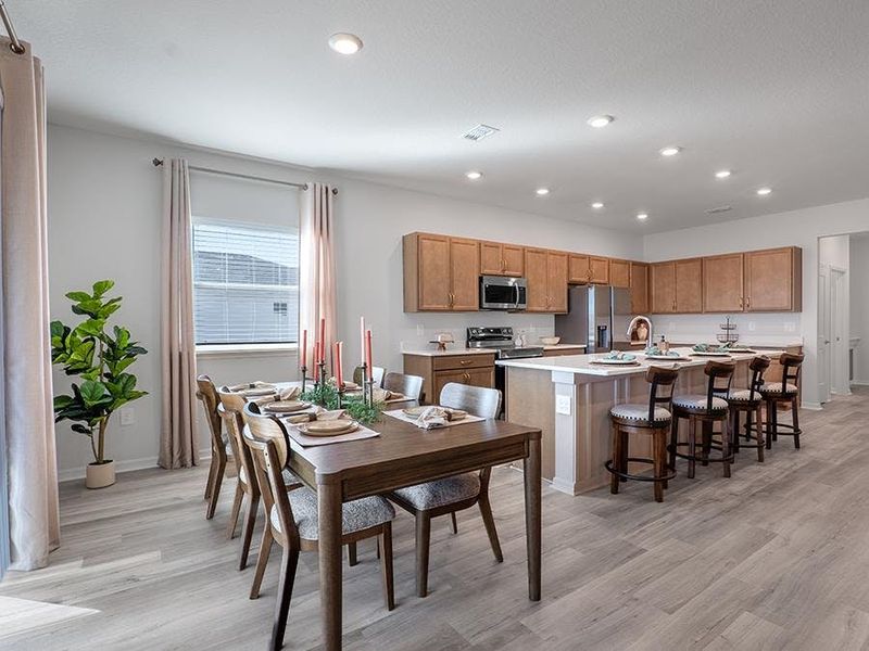 Meals are a delight in your beautiful kitchen with seating at the island and adjacent sunny dining cafe - Monroe by Highland Homes Meals are a delight in your beautiful kitchen with seating at the island and adjacent sunny dining cafe - Monroe by Highland Homes