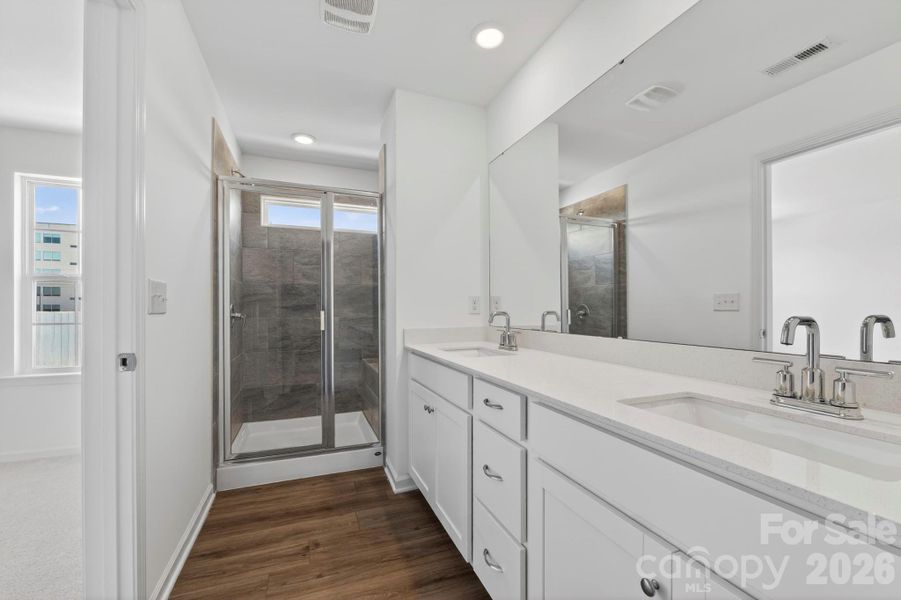 Owners spa like bathroom with tiled shower and bench seat