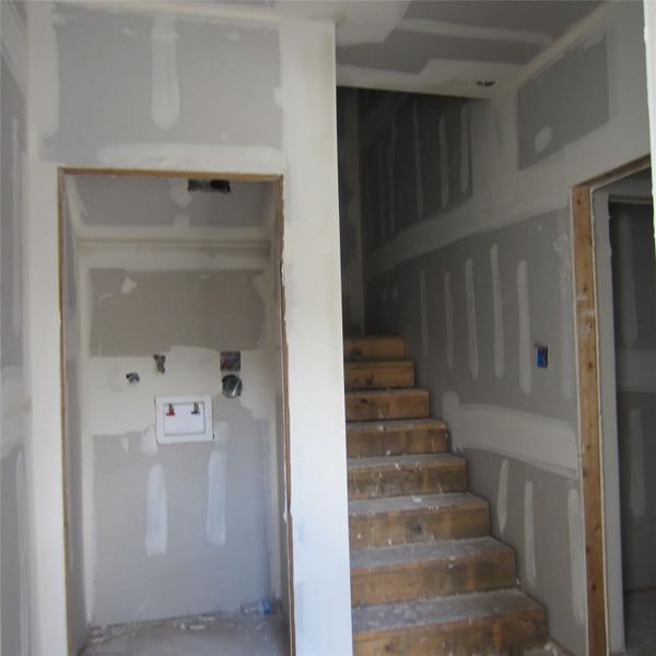 Upon entering the front door, you will see the utility room, stairs, a bedroom with full bath to the right, and next to the front door is the garage.