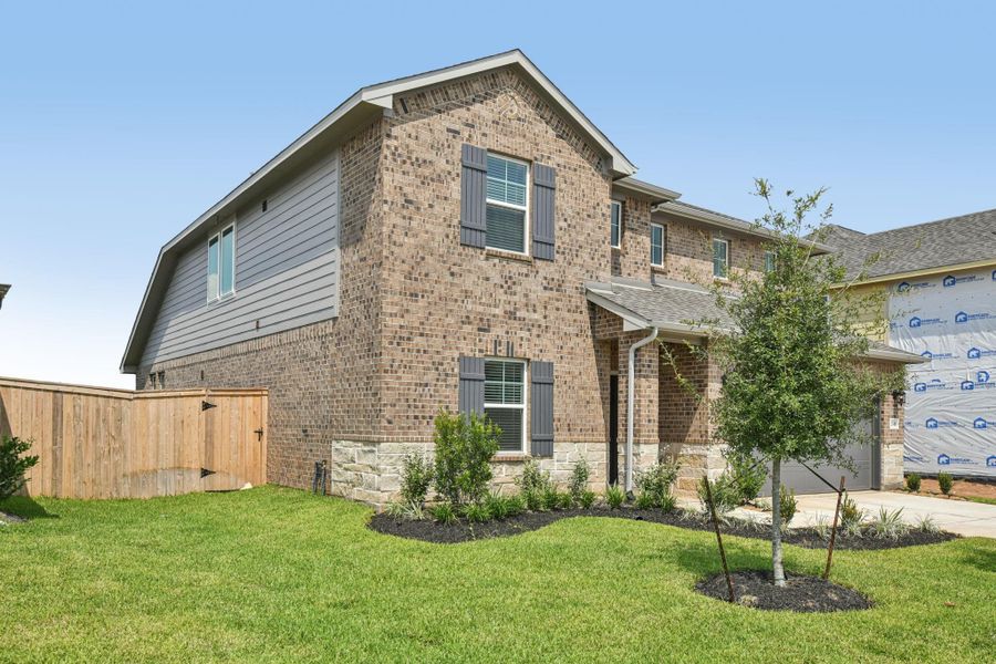 Front exterior of a new home in Kingdom Heights, Rosenberg, TX, highlighting curb appeal (Image 24).