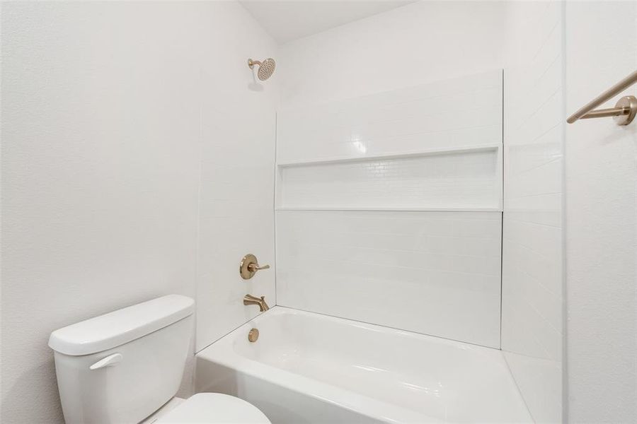 Bathroom with shower / bathtub combination and toilet