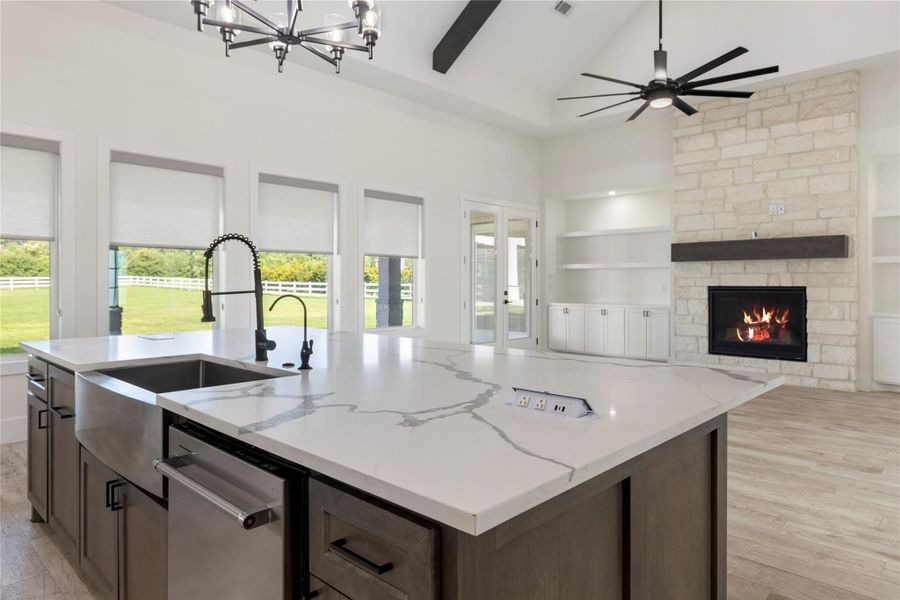 The kitchen is open to the family or living room with plenty of windows to allow for natural light. All of the windows have remote controlled window shades. The kitchen is open to the family or living room with plenty of windows to allow for natural light. All of the windows have remote controlled window shades.