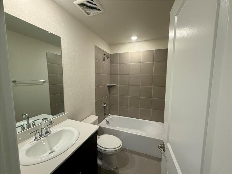 Bathroom featuring a vanity with an oval sink, chrome faucet, and solid surface countertop Bathroom featuring a vanity with an oval sink, chrome faucet, and solid surface countertop