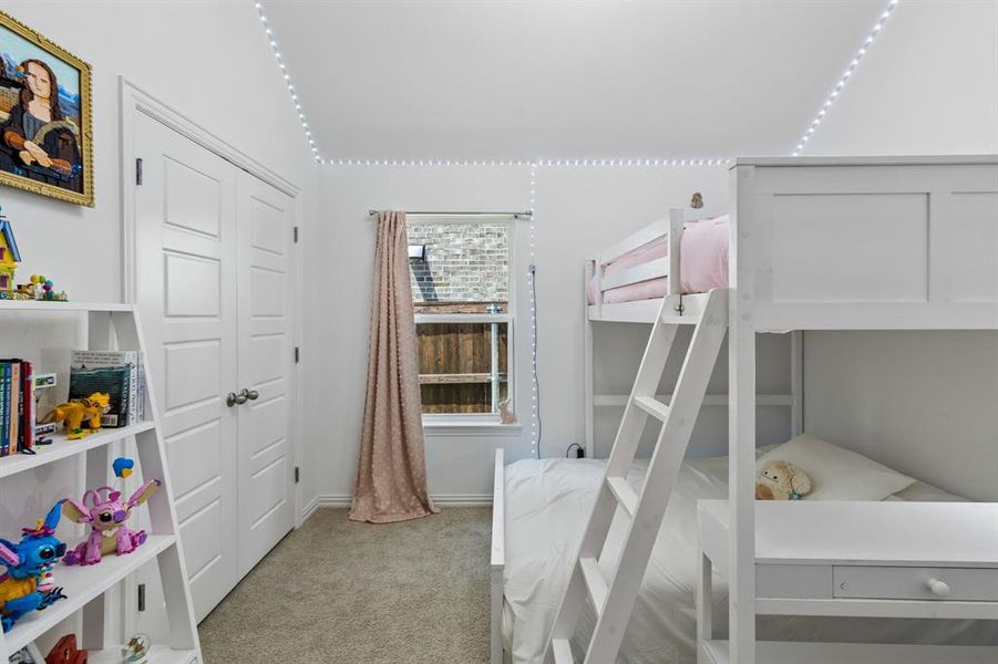 Carpeted room featuring a white interior, double-panel closet doors, a single window with blinds, and white trim