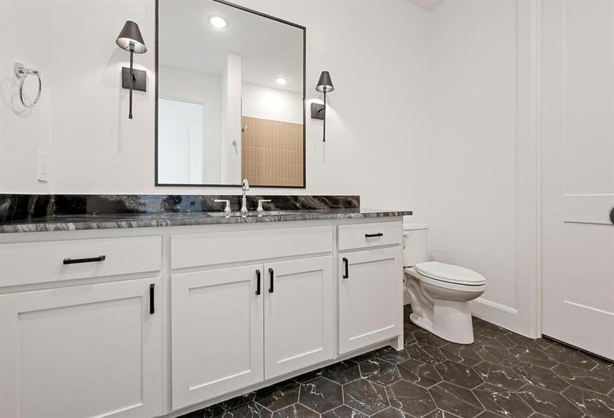 Bathroom featuring vanity and toilet