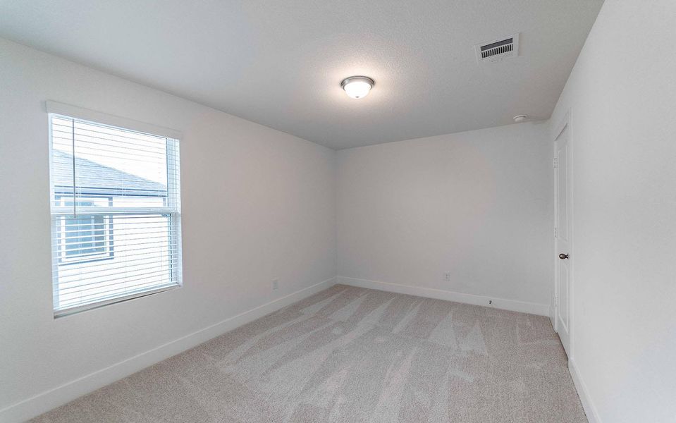 Spare room with baseboards and light carpet Spare room with baseboards and light carpet