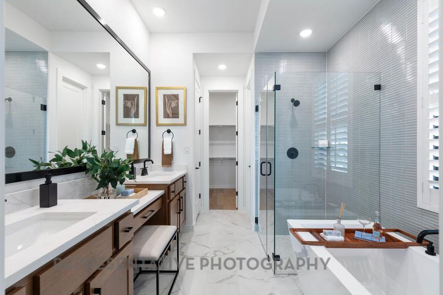 Full bathroom with a stall shower, double vanity, marble finish floors, a soaking tub, and a spacious closet Full bathroom with a stall shower, double vanity, marble finish floors, a soaking tub, and a spacious closet