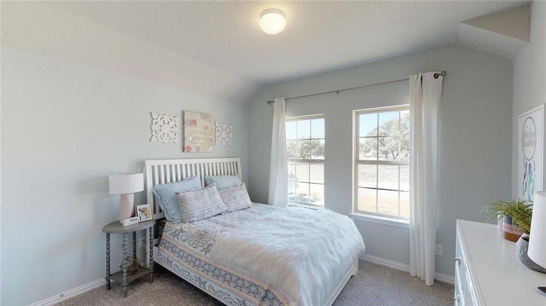Bedroom featuring light carpet and lofted ceiling Bedroom featuring light carpet and lofted ceiling