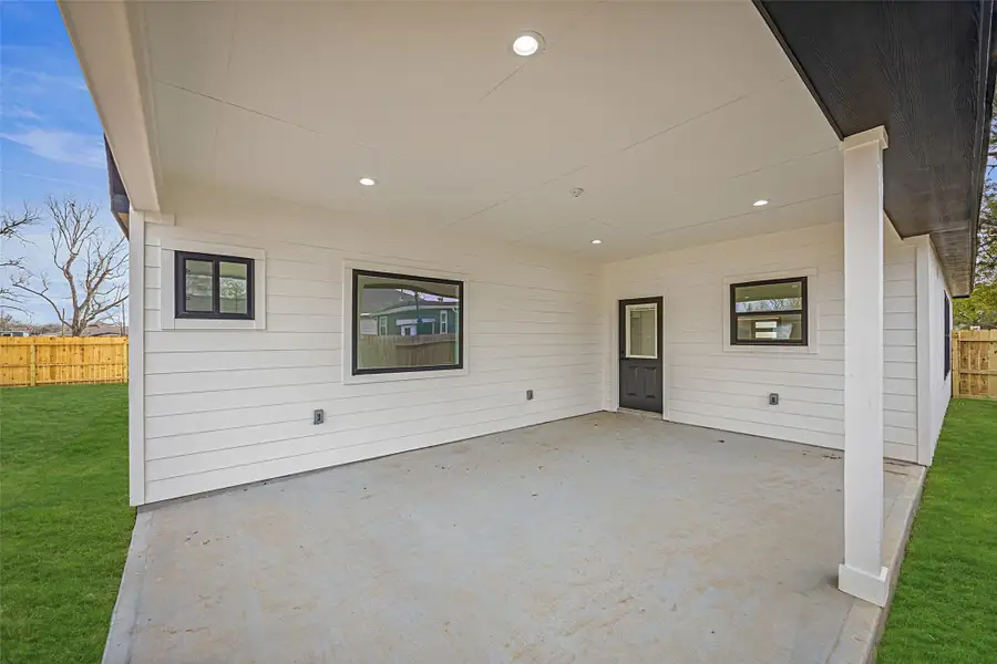 Large covered outdoor living space with recessed lighting, concrete slab, and direct access to the home—ideal for entertaining.