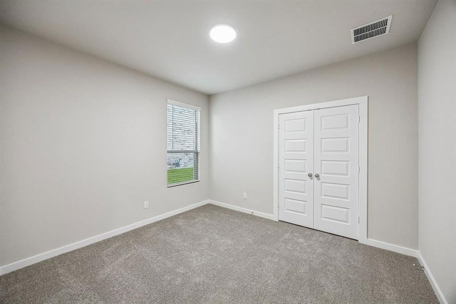 Bedroom in the Wimbledon home plan by Trophy Signature Homes – REPRESENTATIVE PHOTO Bedroom in the Wimbledon home plan by Trophy Signature Homes – REPRESENTATIVE PHOTO