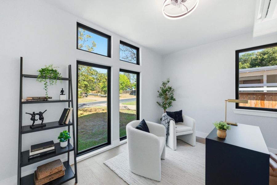 Sitting room featuring wood finished floors and baseboards Sitting room featuring wood finished floors and baseboards