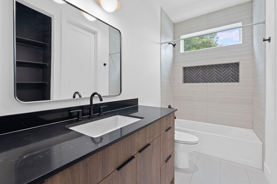 Full bath with tub / shower combination, vanity, and tile patterned floors