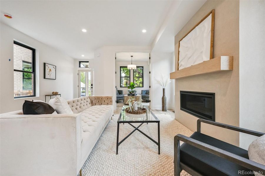 Living room has a gas fireplace with a den/home office adjacent