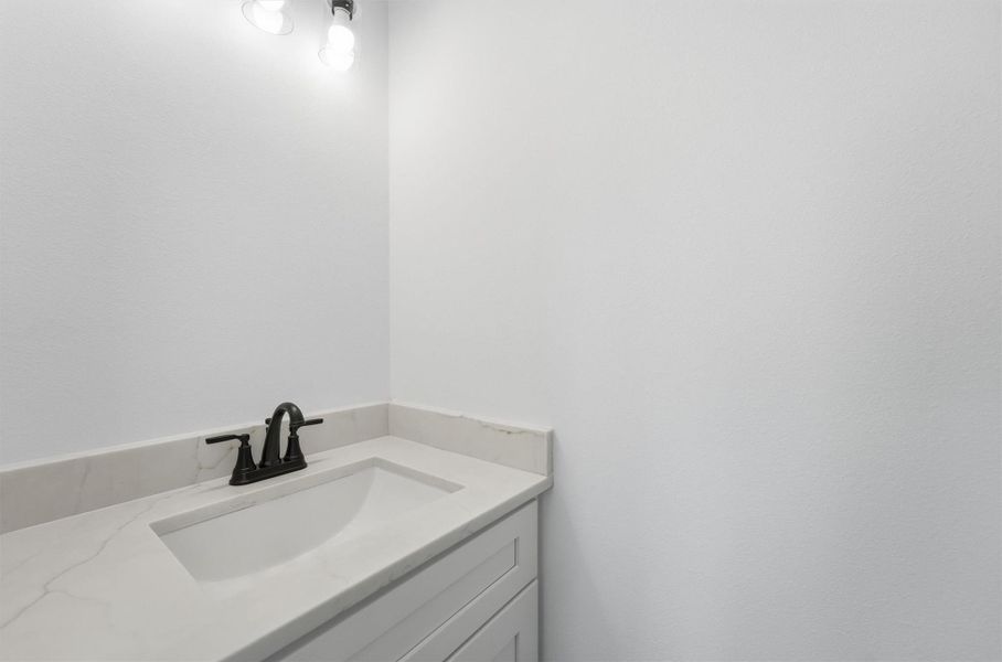 Even the details are done right. This stylish half bath with an undermount sink and quartz countertop, white shaker vanity, and matte black faucet proves that great design lives in every corner of this home. Even the details are done right. This stylish half bath with an undermount sink and quartz countertop, white shaker vanity, and matte black faucet proves that great design lives in every corner of this home.