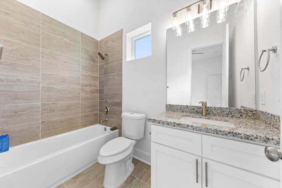 Another full bathroom with modern finishes, sleek vanity, and a clean, polished look.