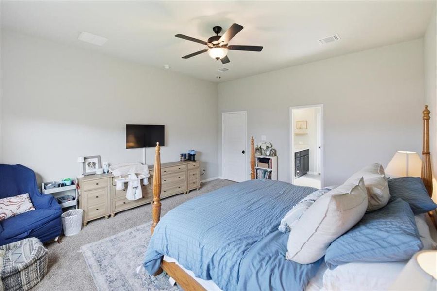 Carpeted bedroom featuring ceiling fan Carpeted bedroom featuring ceiling fan