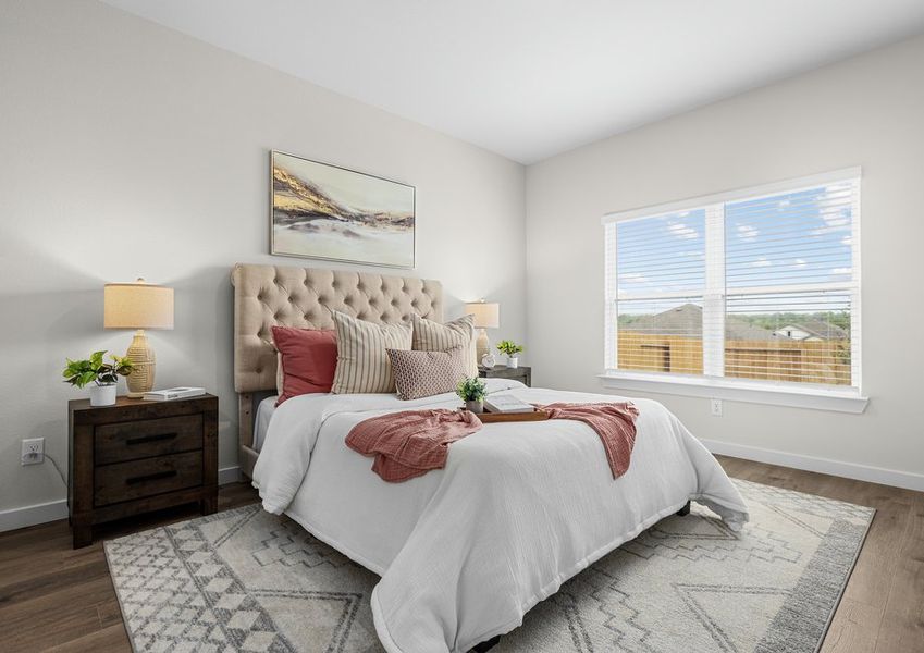 The master bedroom is spacious and has a large window.