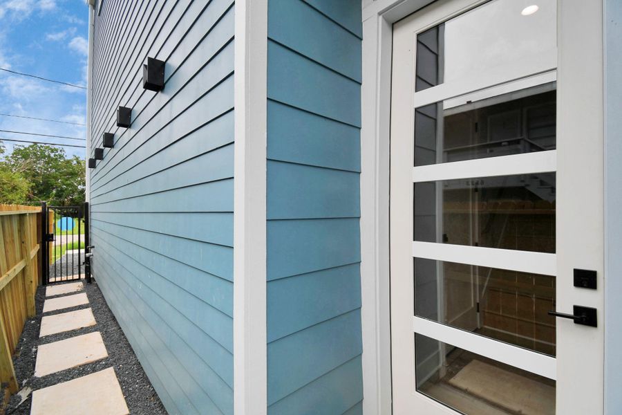 Private front entry with modern door design and clean exterior finishes. Gated access adds both security and convenience.