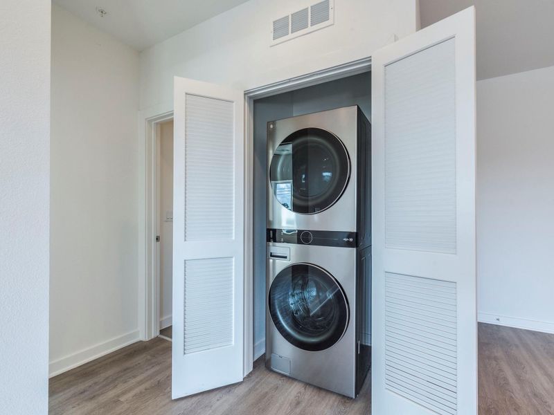 Laundry area with stacked washer and clothes dryer Laundry area with stacked washer and clothes dryer