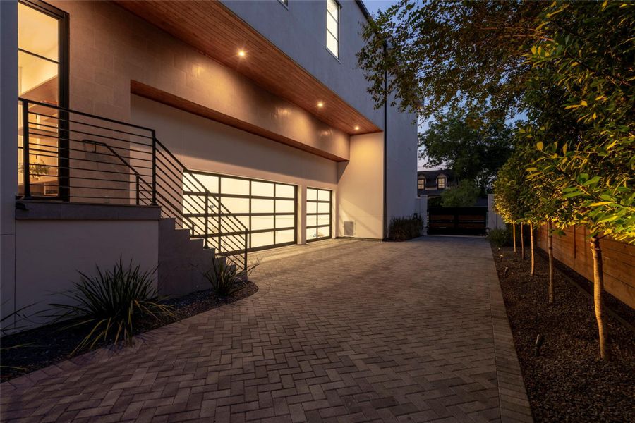 Gated entry to 3-car garage. There is a side entrance to the east hall with access to the mudroom and scullery kitchen. For the collector, the garage was purpose-built with elevated ceiling heights engineered for car lifts. Gated entry to 3-car garage. There is a side entrance to the east hall with access to the mudroom and scullery kitchen. For the collector, the garage was purpose-built with elevated ceiling heights engineered for car lifts.