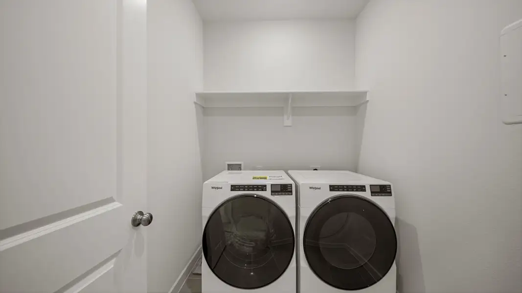 A white wall with a fan and a white door with a white door.