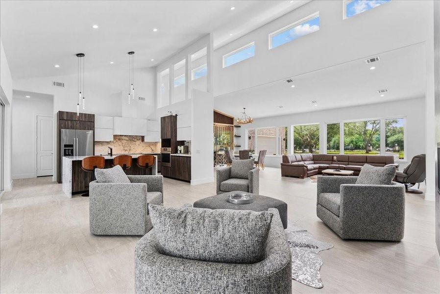 This light-filled great room offers a perfect blend of modern warmth and entertaining on a grand-scale design.