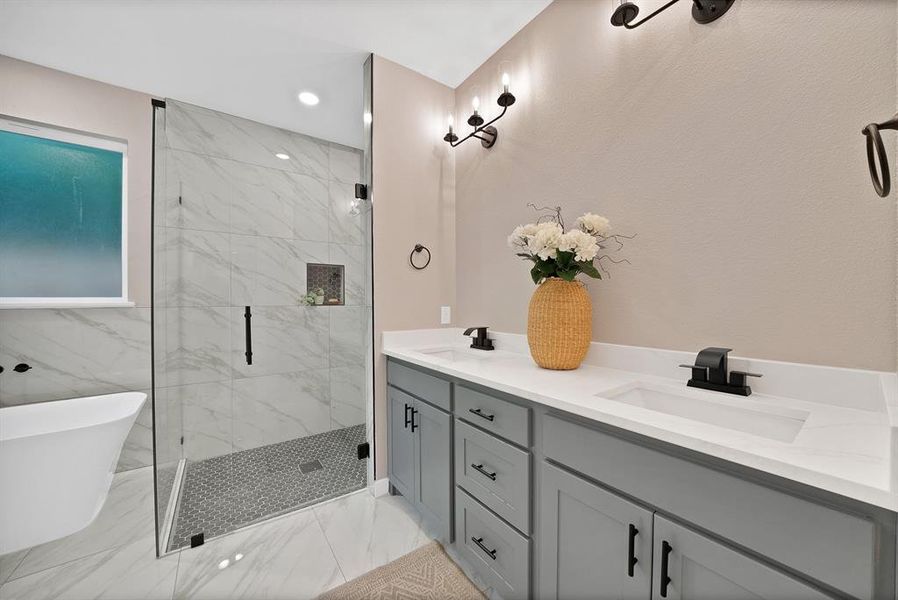 Bathroom featuring a frameless glass shower enclosure with marble-look tile surround and mosaic tile floor Bathroom featuring a frameless glass shower enclosure with marble-look tile surround and mosaic tile floor