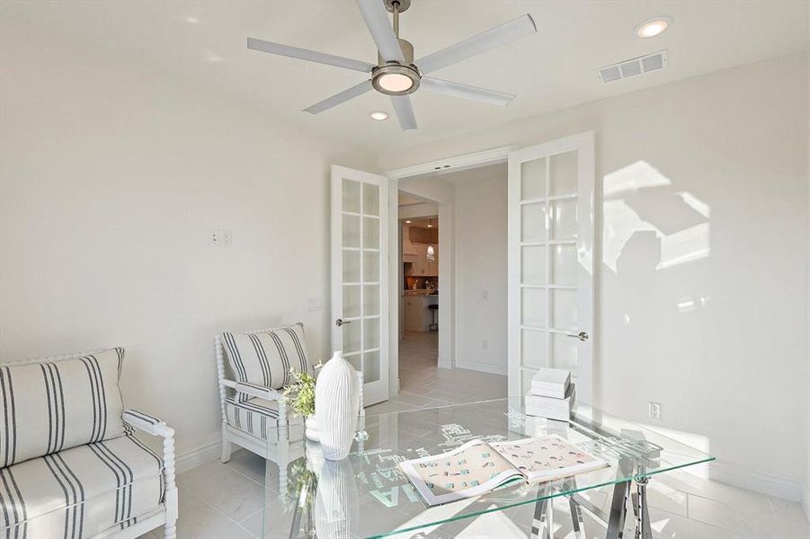 Living room with ceiling fan, french doors, and light tile flooring