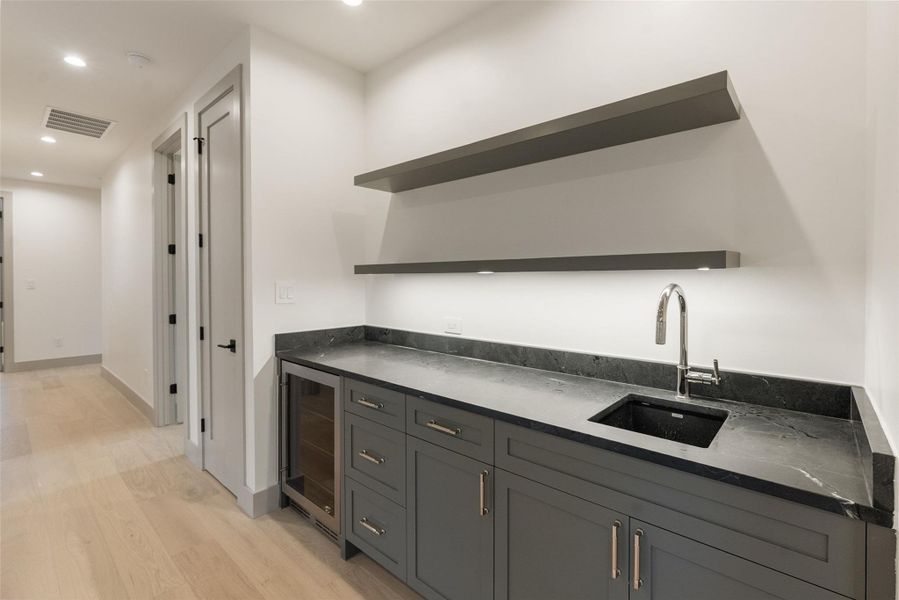 Wet bar with beverage fridge.