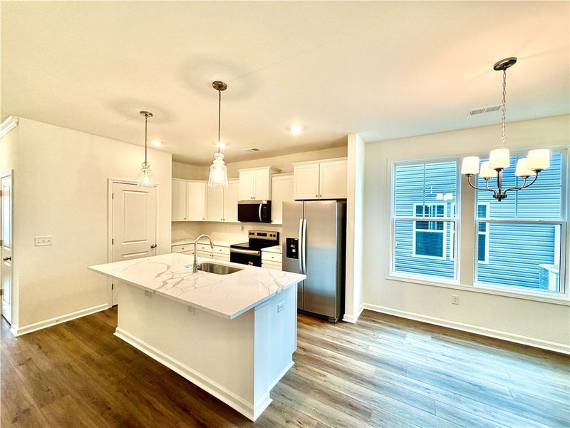 Gleaming stone countertops and warm wood floors de