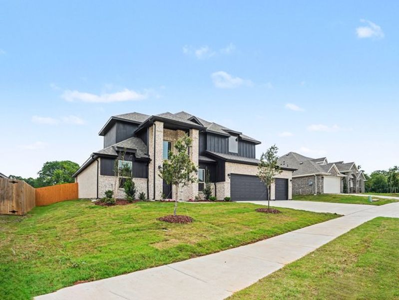 Front exterior of a new home in Cole Crossing Estates, DeSoto, TX, highlighting curb appeal (Image 14).