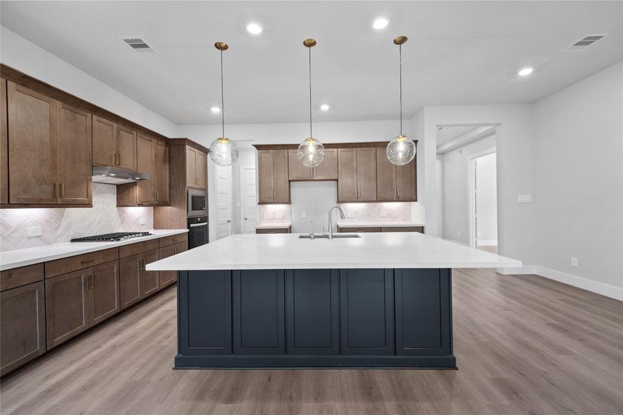 This spacious kitchen has it all—ample storage, generous counter space, and a layout that truly makes it the heart of the home.