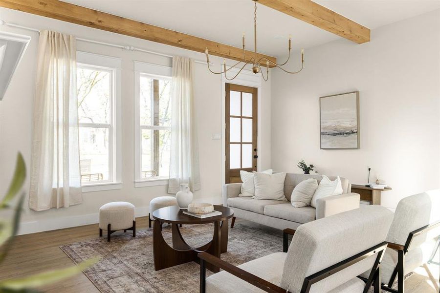 Living area featuring an inviting chandelier, beamed ceiling, baseboards, and wood finished floors