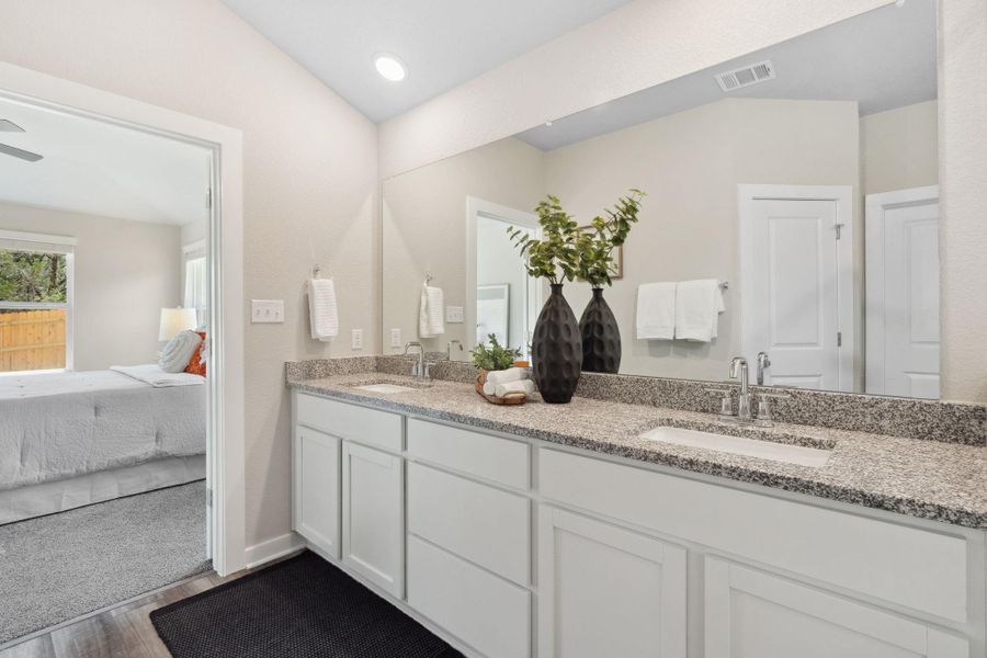 primary bathroom with dual vanities