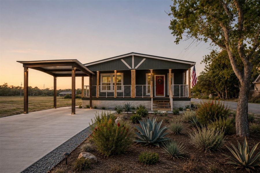 A welcoming front porch with natural wood accents sets the stage for this charming home with modern landscaping. A welcoming front porch with natural wood accents sets the stage for this charming home with modern landscaping.