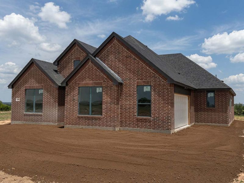 Front exterior of a new home in Stagecoach Crossing, Bridgeport, TX, highlighting curb appeal (Image 1). Front exterior of a new home in Stagecoach Crossing, Bridgeport, TX, highlighting curb appeal (Image 1).