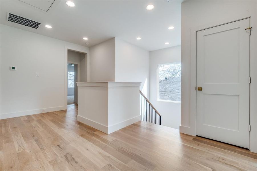 Hall with light hardwood / wood-style flooring