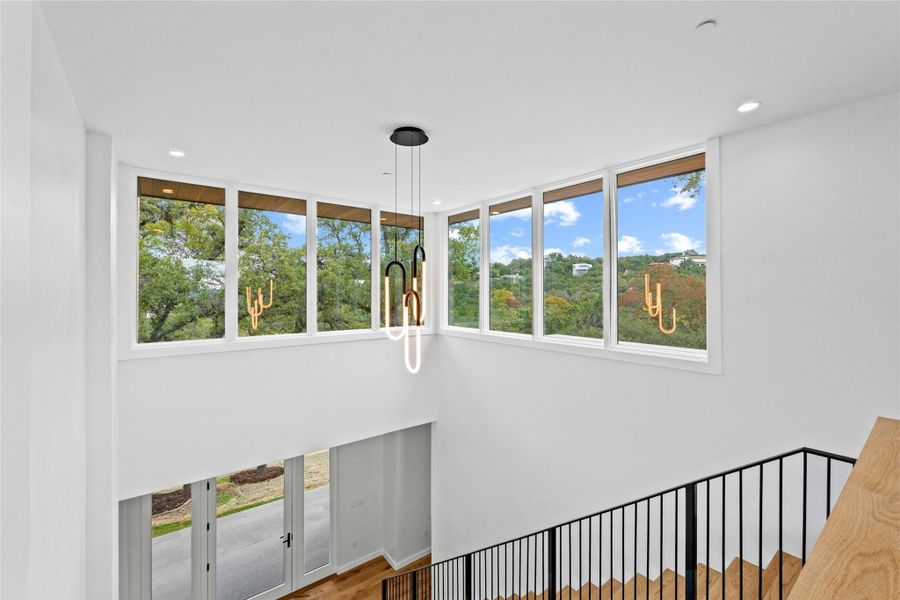 At the top of the stairs the Sierra Pacific Custom Aluminun Clad Wood Windows showcae the distant hill country. Windows are argon filled, Energy Star Rated, Low E 366, with Black Warm Edge Spacer.