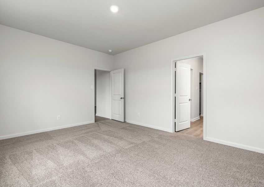 The master suite has a large bedroom, ensuite bathroom and a walk-in closet.