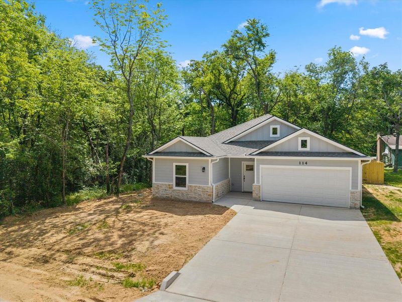 Front exterior of a new home in , Payne Springs, TX, highlighting curb appeal (Image 15). Front exterior of a new home in , Payne Springs, TX, highlighting curb appeal (Image 15).