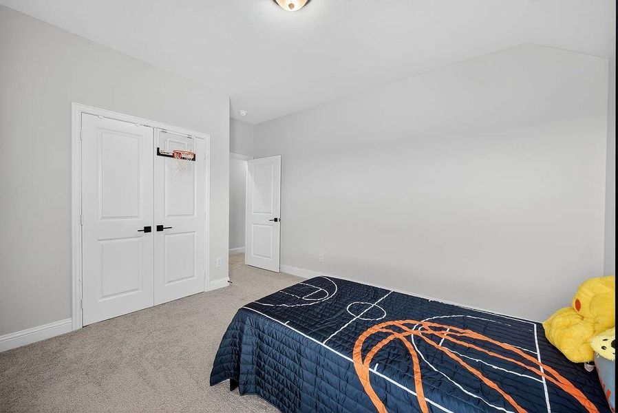 Neutral wall paint throughout, featuring a double-door closet with black hardware, and a single hinged door