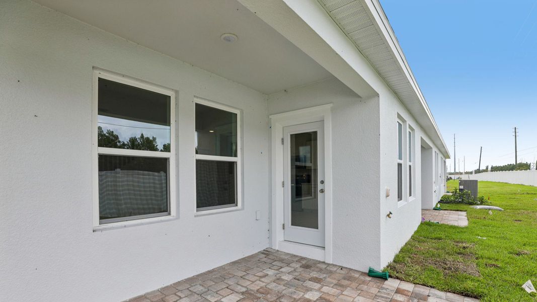 Exterior details and patio area of a home in Cyrene at Harmony, St. Cloud (Image 21).