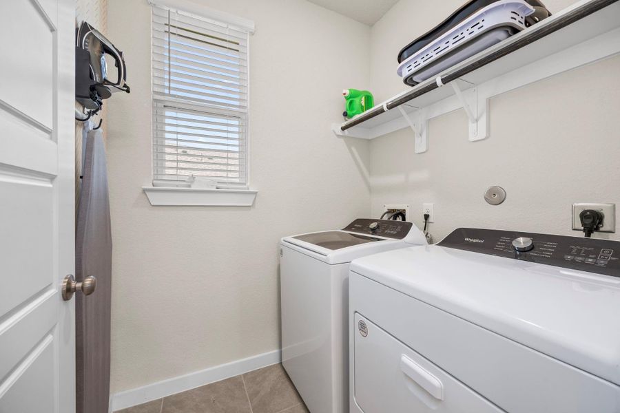 Functional and efficient, the home's laundry room is equipped with your washer and dryer already installed, as well as a shelf for all your laundry essentials.