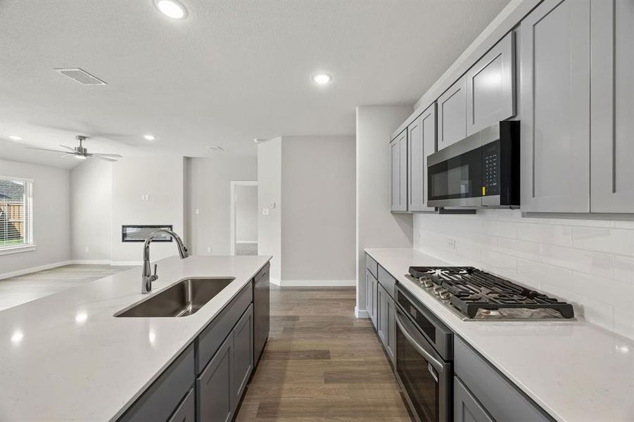 Kitchen in the Emmy II home plan by Trophy Signature Homes - REPRESENTATIVE PHOTO