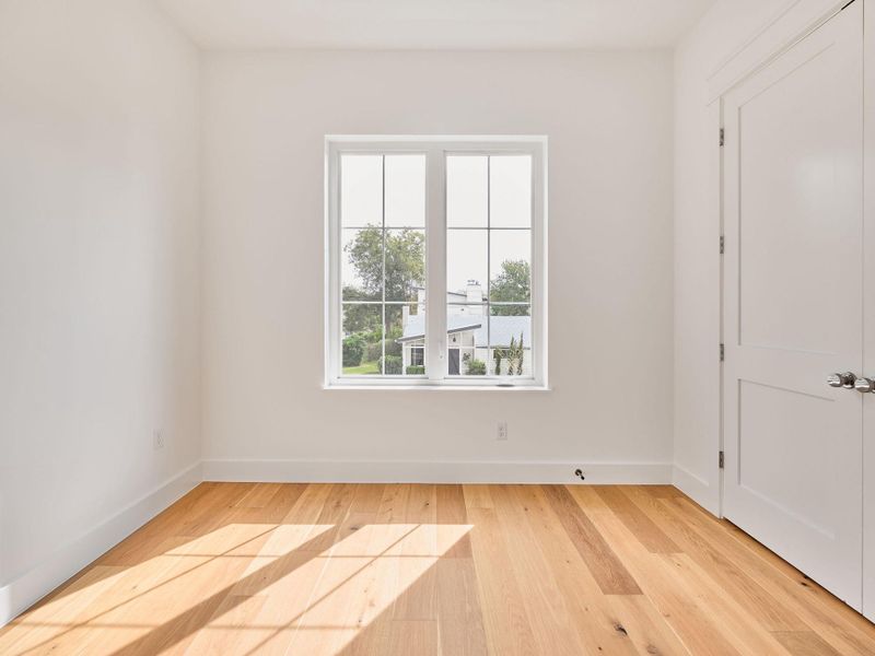 Unfurnished room with light wood-type flooring and baseboards Unfurnished room with light wood-type flooring and baseboards