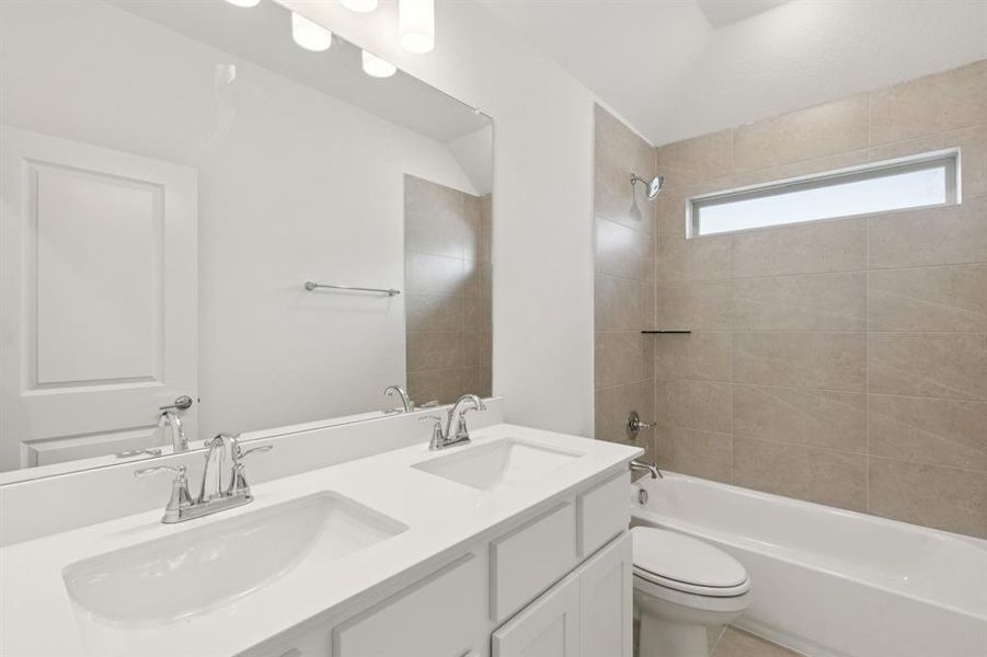 Full bath featuring shower combination and double vanity Full bath featuring shower combination and double vanity