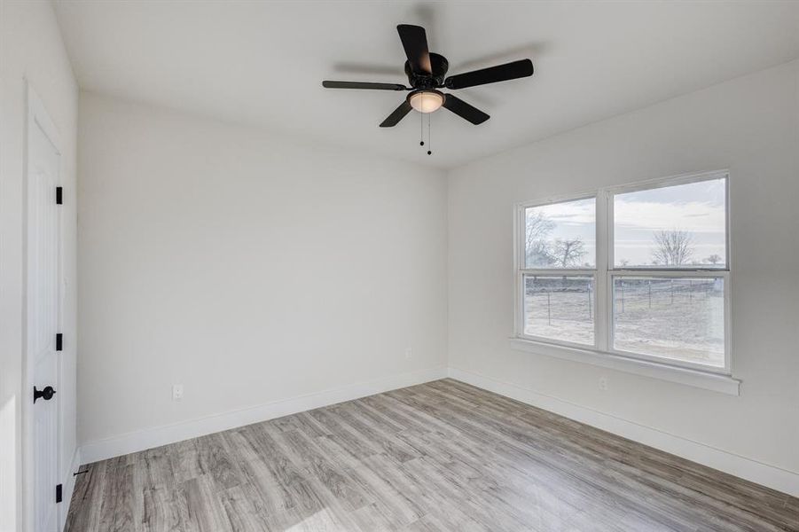 Spare room with ceiling fan and light hardwood / wood-style floors