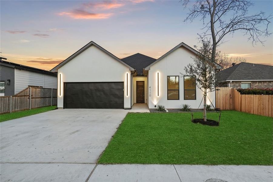 Ranch-style home with a yard and a garage