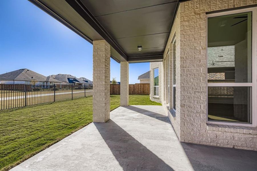 Fenced backyard with a patio area and a residential view